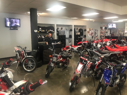 Multiple motorcycles lined up on the Brewer Cycles floor.